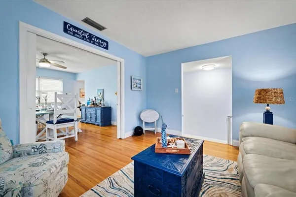 a living room with furniture and wooden floor