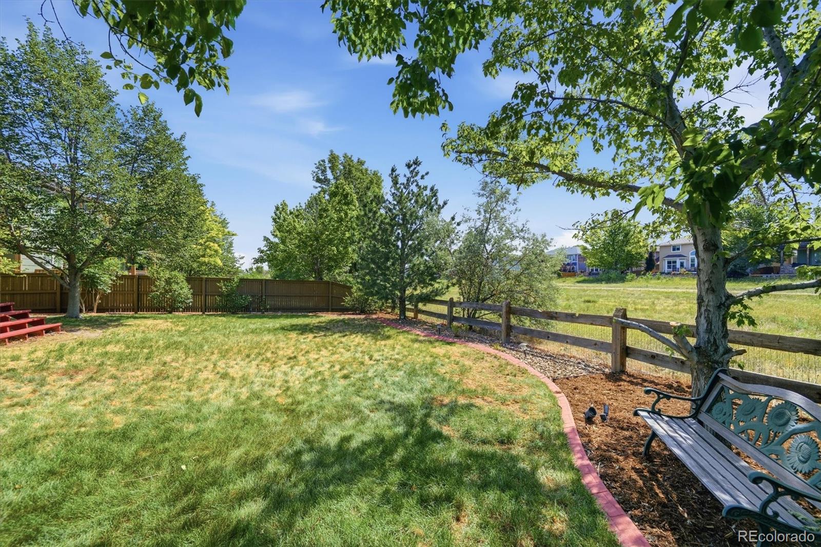 9629 Burberry Way Highlands Ranch, CO 80129 - Photo 42 of 50 a view of a garden with wooden fence