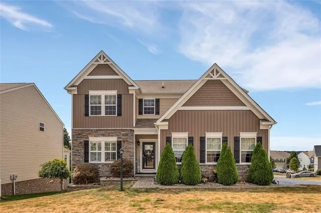 a front view of a house with a yard
