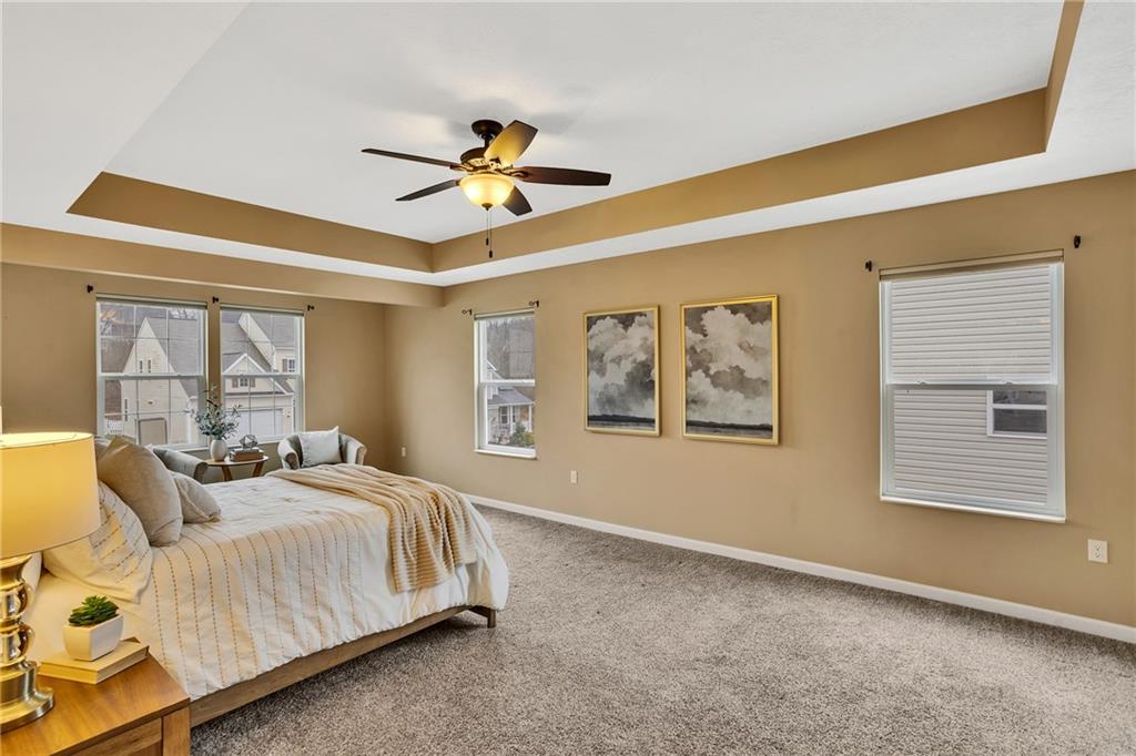 201 Millstream Lane Zelienople, PA 16063 - Photo 21 of 48 a spacious bedroom with a bed a couch and a window
