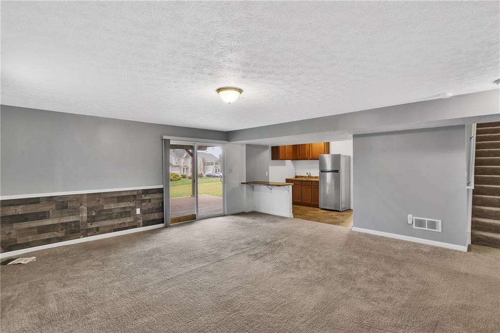201 Millstream Lane Zelienople, PA 16063 - Photo 31 of 48 a view of a big room with wooden floor and windows