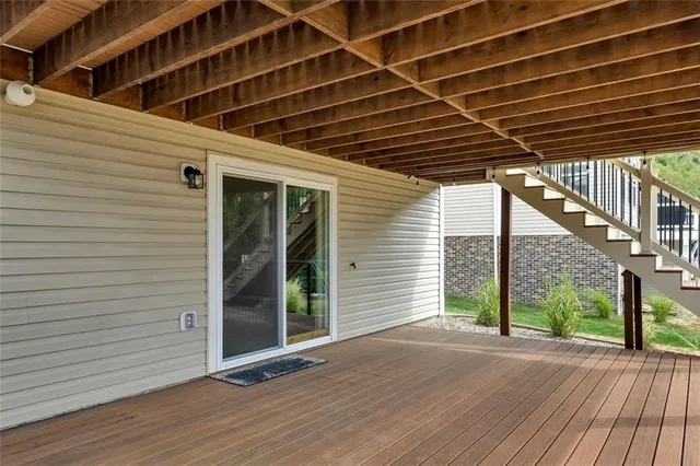 a view of a porch with wooden floor and brick walls