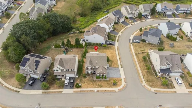 an aerial view of a house with a swimming pool