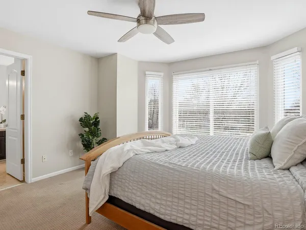 a bedroom with a bed and a potted plant