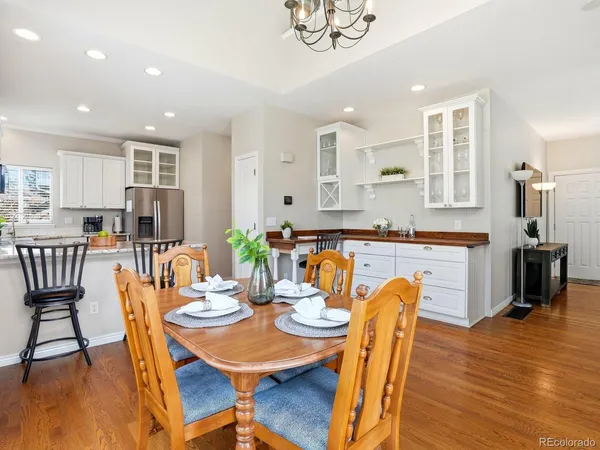 a view of a dining room with furniture and wooden floor