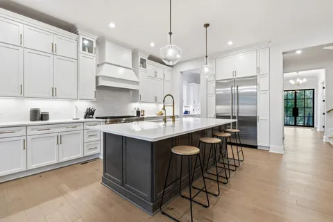 a stove top oven sitting inside of a kitchen