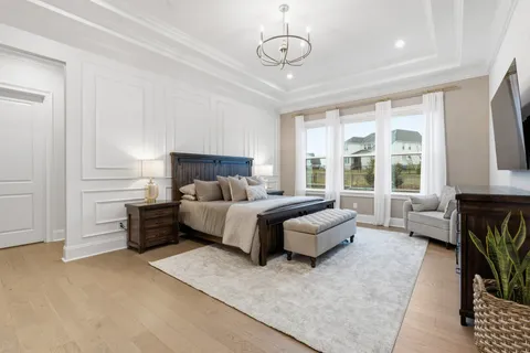 a spacious bathroom with a bathtub double sink and mirror