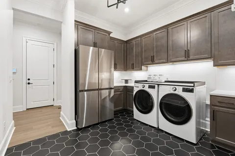 a kitchen with stainless steel appliances a sink cabinets and wooden floor