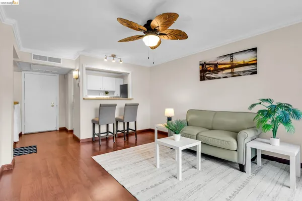 a living room with furniture and a dining table