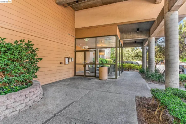 a view of a porch with wooden floor and iron fence