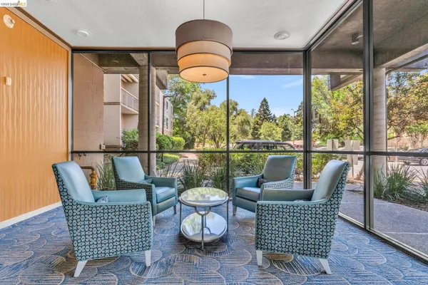 a balcony view with a seating space and a potted plant