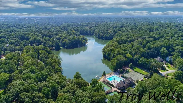 an aerial view of residential house with outdoor space and lake view
