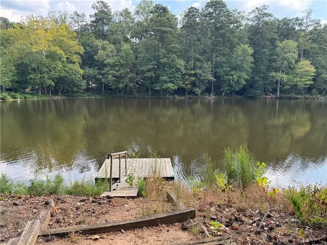 a view of a lake in between two chairs
