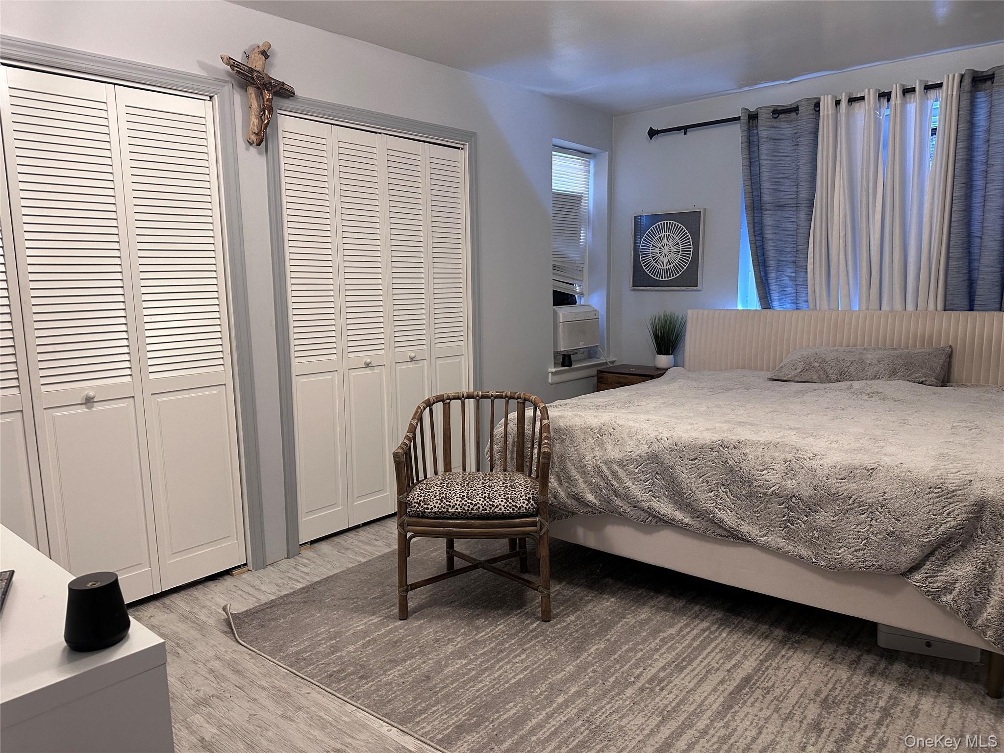 250 West Merrick Road, Unit 2F Freeport, NY 11520 - Photo 11 of 30 a bedroom with a bed and a window