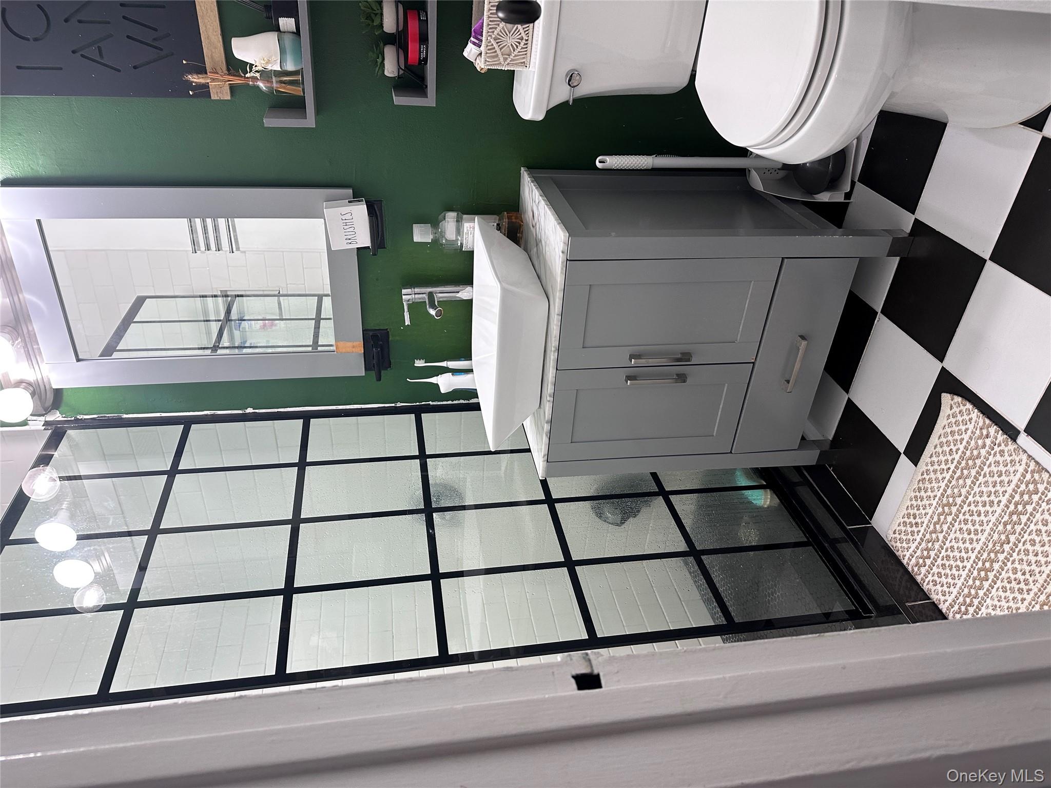 250 West Merrick Road, Unit 2F Freeport, NY 11520 - Photo 13 of 30 a bathroom with a sink toilet and window