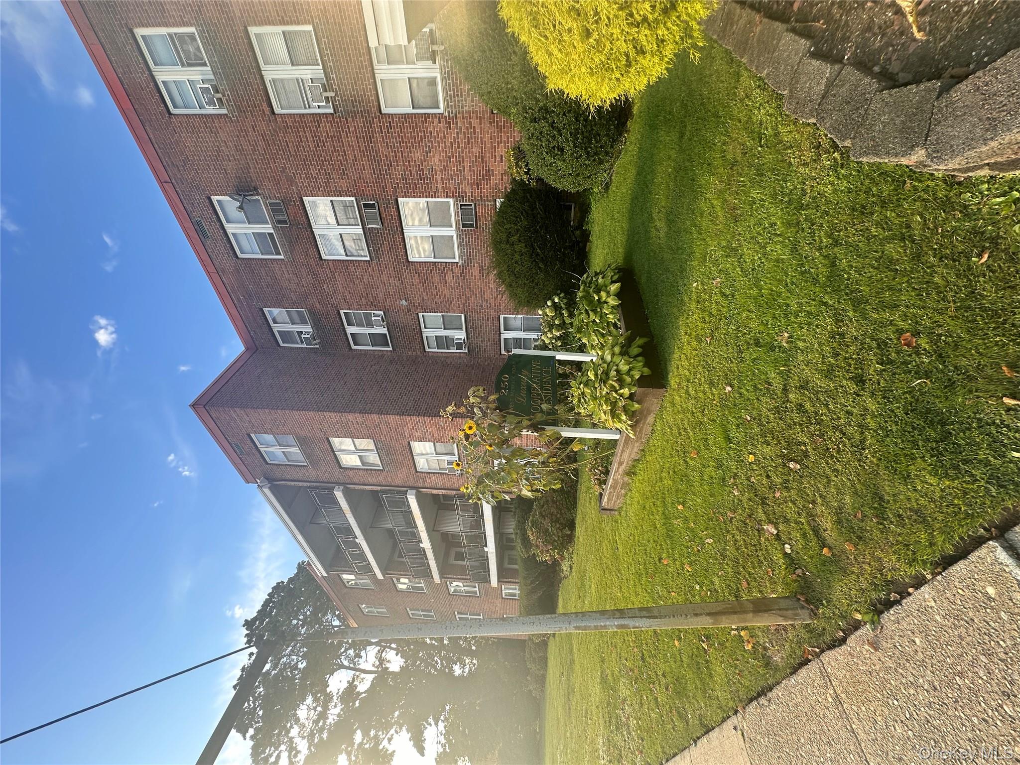 250 West Merrick Road, Unit 2F Freeport, NY 11520 - Photo 19 of 30 a view of a house with a yard and plants
