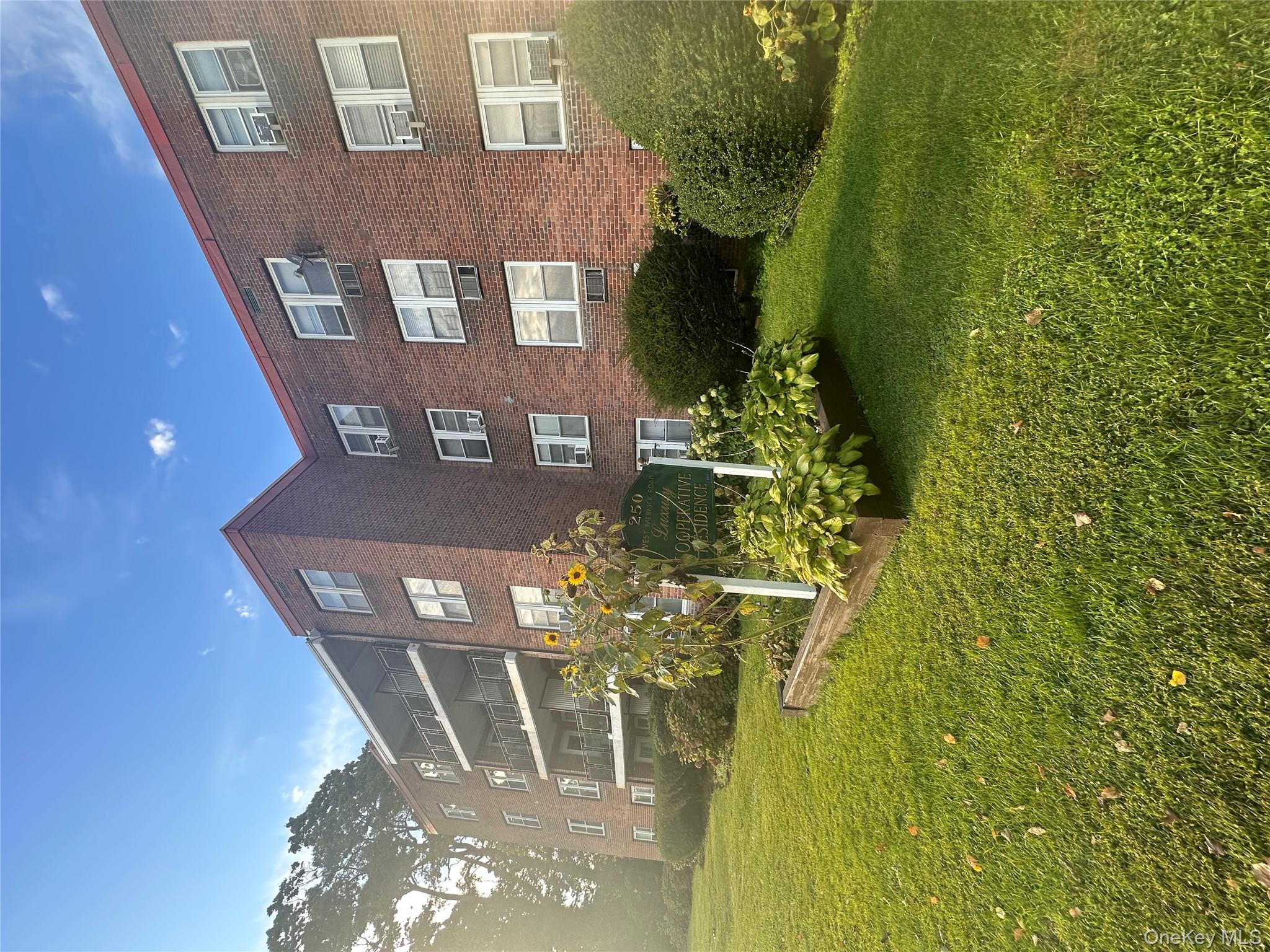 250 West Merrick Road, Unit 2F Freeport, NY 11520 - Photo 20 of 30 a front view of a house with garden