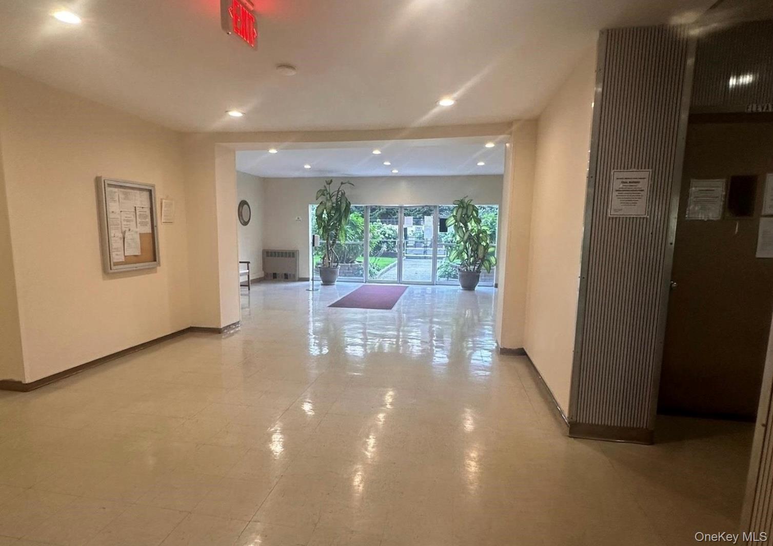 250 West Merrick Road, Unit 2F Freeport, NY 11520 - Photo 25 of 30 a lobby with furniture and floor to ceiling window