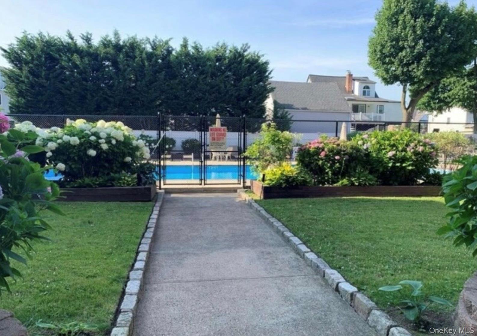 250 West Merrick Road, Unit 2F Freeport, NY 11520 - Photo 27 of 30 a view of a garden with large trees