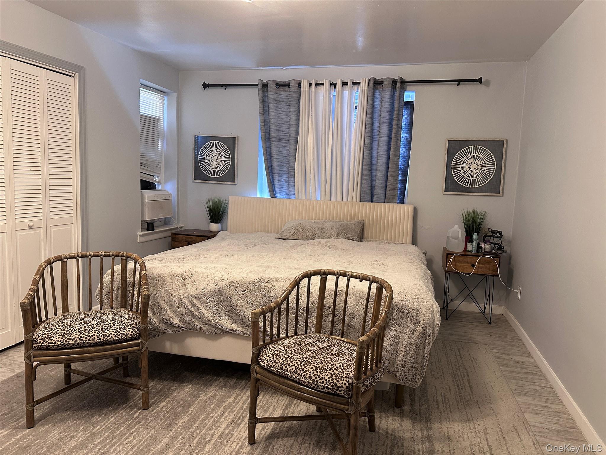 250 West Merrick Road, Unit 2F Freeport, NY 11520 - Photo 10 of 30 a bedroom with a bed window and a chair