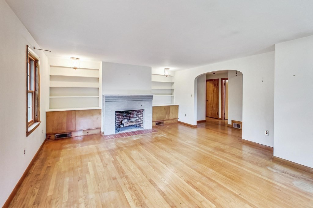 22 Ferry Road Salisbury, MA 01952 - Photo 8 of 34 a view of empty room with wooden floor and fireplace