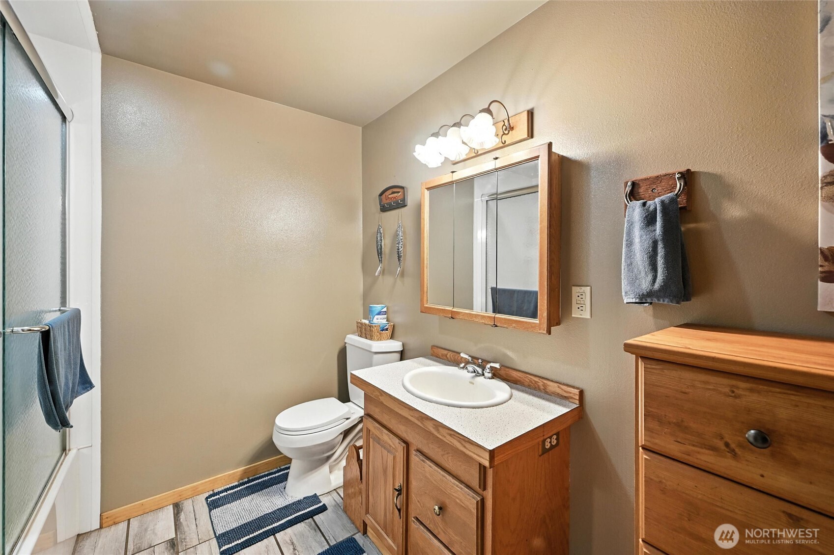 5149 Elder Road Ferndale, WA 98248 - Photo 15 of 40 a bathroom with a sink toilet a mirror and vanity