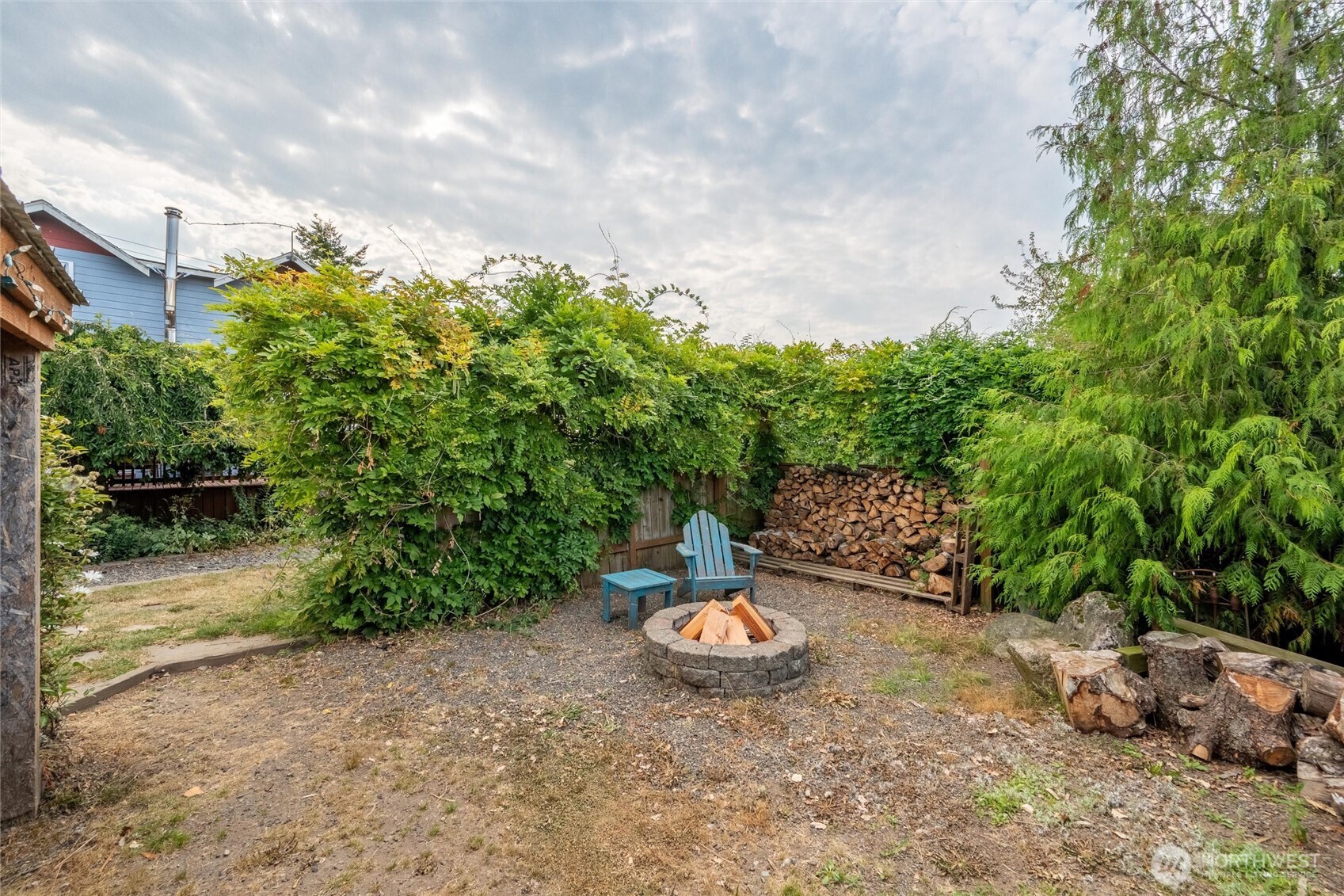 5149 Elder Road Ferndale, WA 98248 - Photo 29 of 40 a view of a backyard with table and chairs plants and large trees