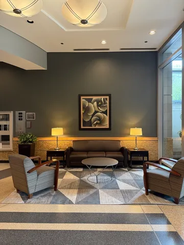 a living room with furniture and a lamp