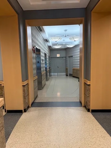 a view of a hallway with wooden walls