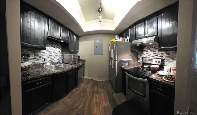 a kitchen with granite countertop stainless steel appliances and wooden cabinets