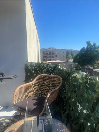 a view of balcony with furniture