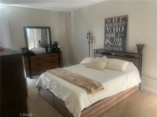 a bedroom with a bed and a mirror