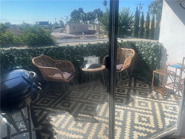 a view of a balcony with table and chairs