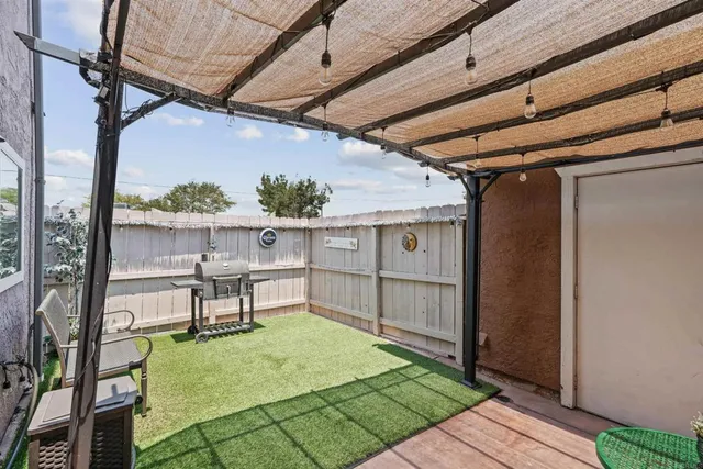 a view of a porch with furniture and a yard