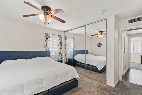 a bedroom with a bed and a chandelier