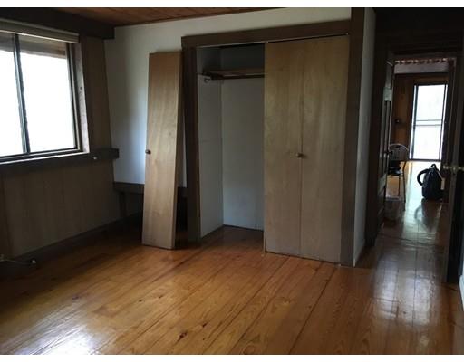 117 Reservation Road Sunderland, MA 01375 - Photo 11 of 30 a view of a hallway with wooden floor and a living room