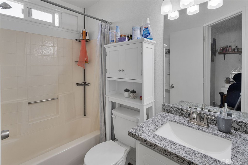 22517 Ojai Road Apple Valley, CA 92308 - Photo 22 of 25 a bathroom with a granite countertop sink toilet and shower