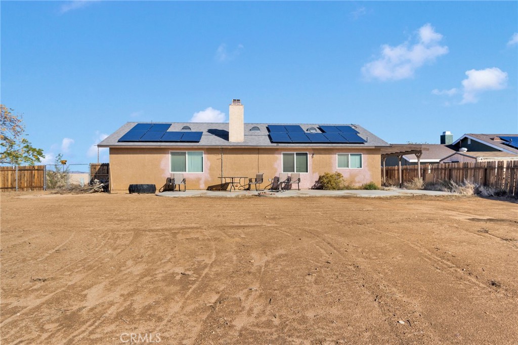22517 Ojai Road Apple Valley, CA 92308 - Photo 25 of 25 a front view of a house with a yard and garage