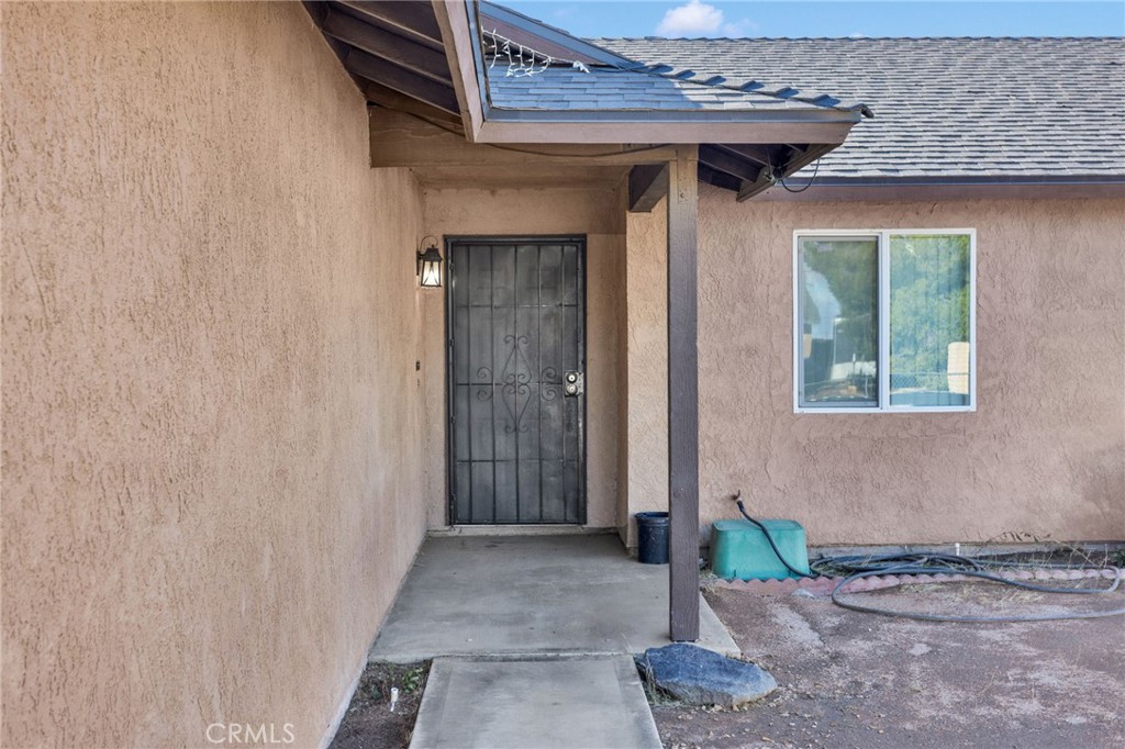 22517 Ojai Road Apple Valley, CA 92308 - Photo 3 of 25 a front view of a house with entryway