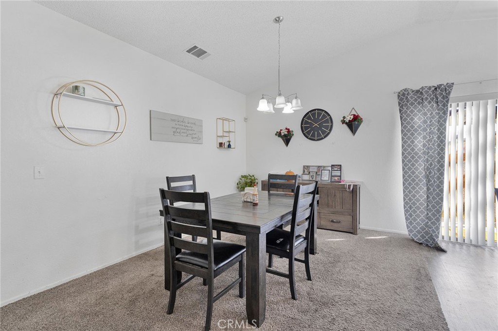 22517 Ojai Road Apple Valley, CA 92308 - Photo 10 of 25 a view of a dining room with furniture and window