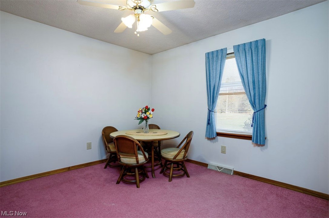 9066 Crow Road Litchfield, OH 44253 - Photo 26 of 28 Carpeted bedroom featuring ceiling fan and a textured ceiling