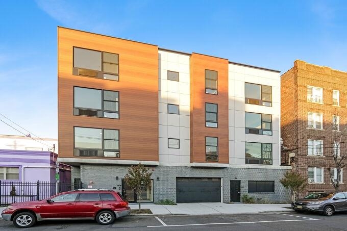 304 61st Street, Unit 1A West New York, NJ 07093 - Photo 3 of 44 a front view of a building with parking space