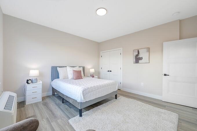 304 61st Street, Unit 1A West New York, NJ 07093 - Photo 39 of 44 a bedroom with a bed and a couch