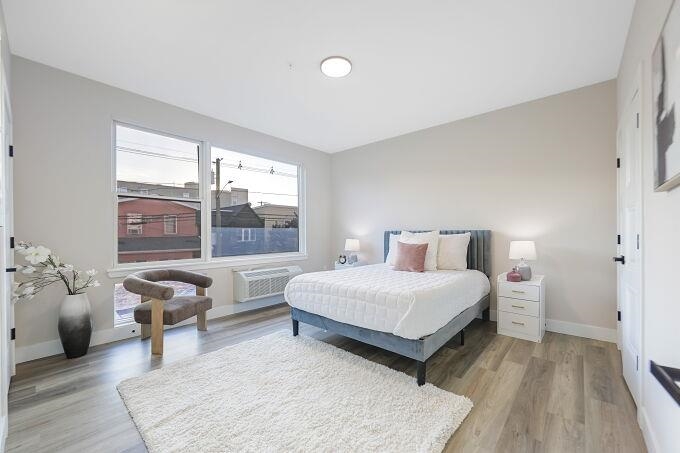 304 61st Street, Unit 1A West New York, NJ 07093 - Photo 40 of 44 a bedroom with a bed and a large window