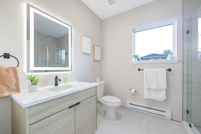 304 61st Street, Unit 1A West New York, NJ 07093 - Photo 43 of 44 a bathroom with a sink vanity granite toilet and a mirror