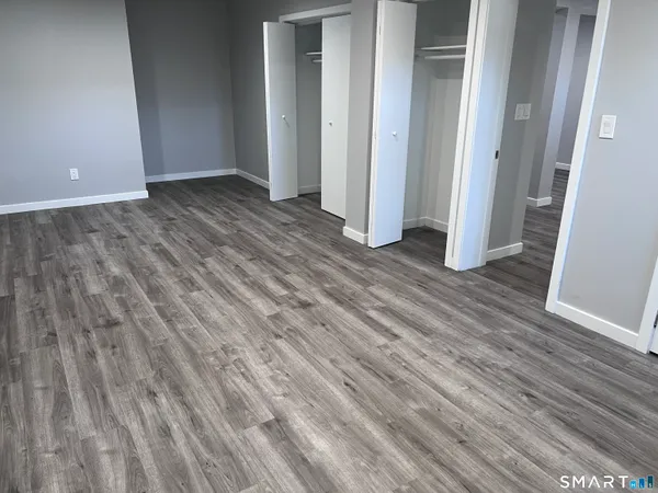 a view of a room with wooden floor