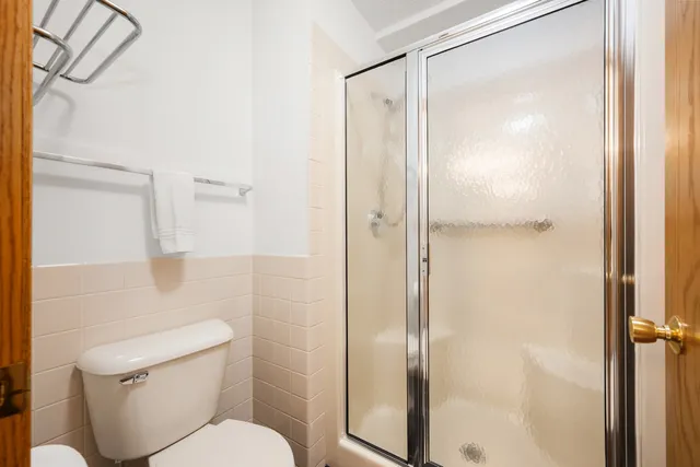 a bathroom with a shower and a toilet