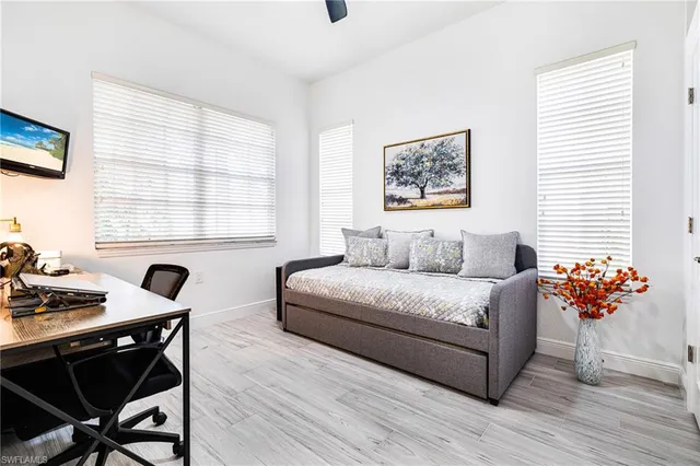 a living room with furniture and flowers