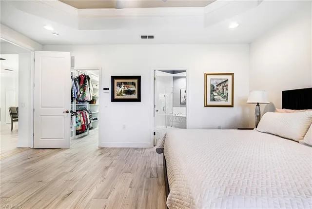 a bedroom with a bed and a wooden floor