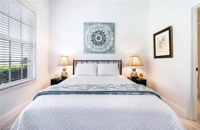 a bedroom with a large bed and a window